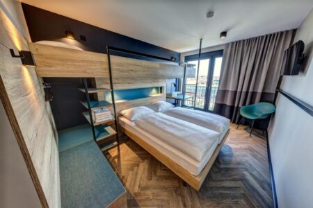 Family room featuring a bunk bed over a double bed, with a view across Berlin.