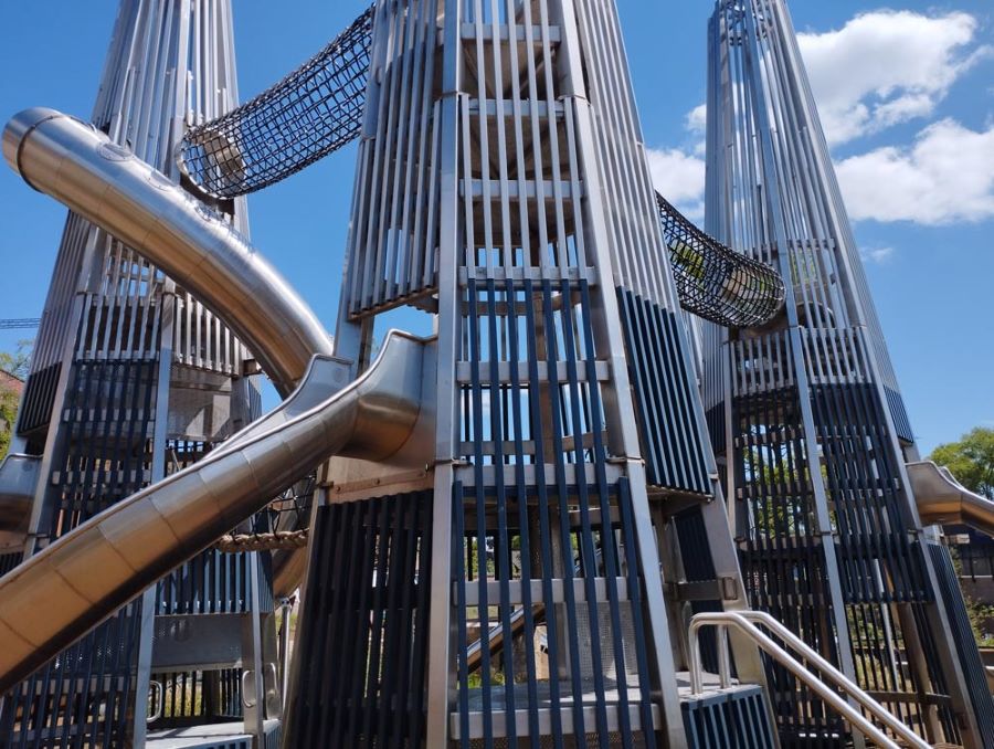 3 metal climbing structures with swooping slides